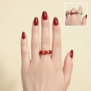 Handmade woven ring with color-blocked beads and colorful floral design