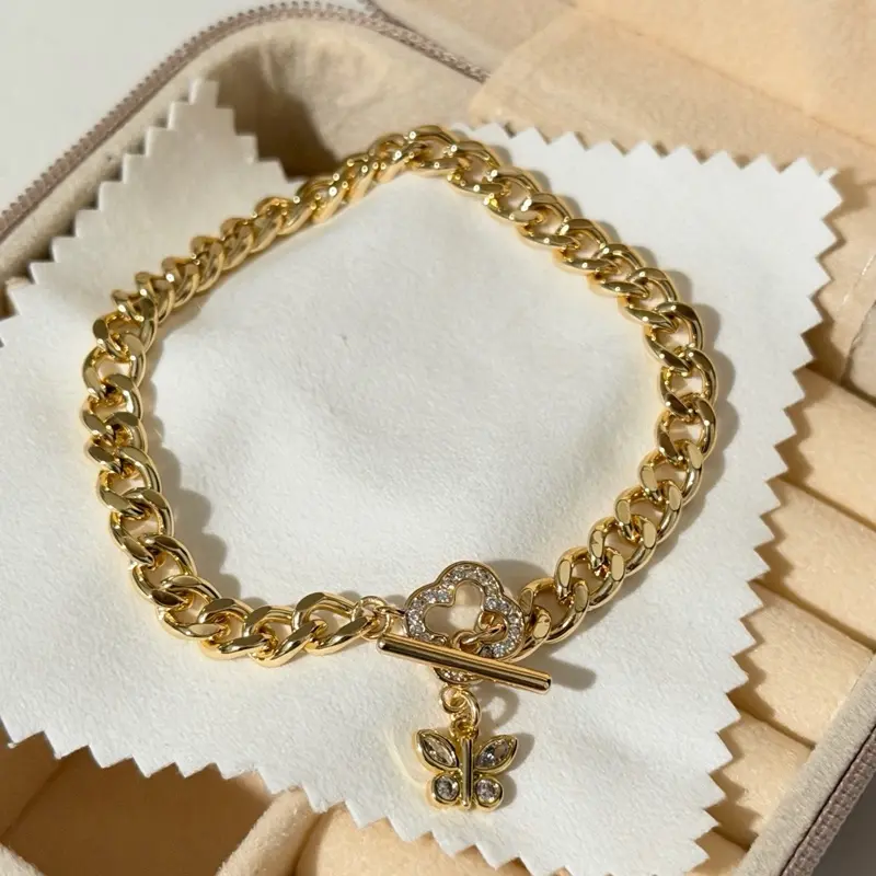 Cuban style bracelet with zirconia clasp and butterfly charm Cuban style bracelet with zirconia clasp and butterfly charm