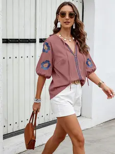 A women's solid color embroidered long-sleeved shirt with a V-neck and a loose top, suitable for summer, suitable for daily leisure seaside vacations.