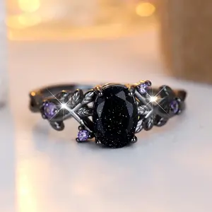 A black gold egg-shaped blue crystal sand-edged purple ring made of synthetic black zirconia is suitable for women to wear daily at wedding parties