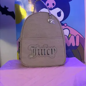 Juicy Couture Beige Backpack with Embossed Logo and Heart Charm for Everyday Use