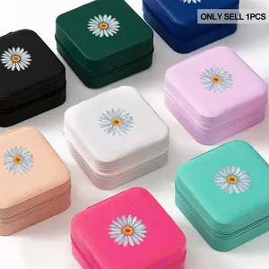 Portable small printed jewelry box with zipper closure, waterproof and lightweight, is an ideal choice for travel storage. The box is printed with a daisy pattern and comes with a necklace display stand, as well as ring and earring compartments
