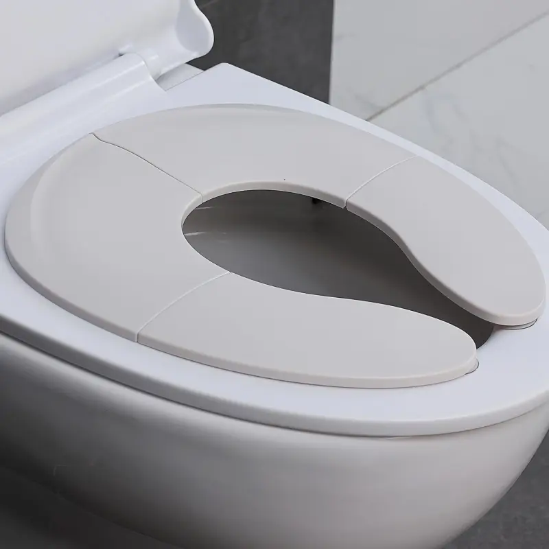 Portable foldable child potty training seat with non-slip suction cup - suitable for travel, boys and girls, and use in RV toilets. Potty Trainer Seat