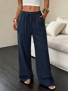 Women’s outdoor casual pants are made from polyester fiber, featuring a drawstring elastic waistband and drapey long design for everyday home wear. Comfortable, versatile beach pants with side pockets and multiple color options.