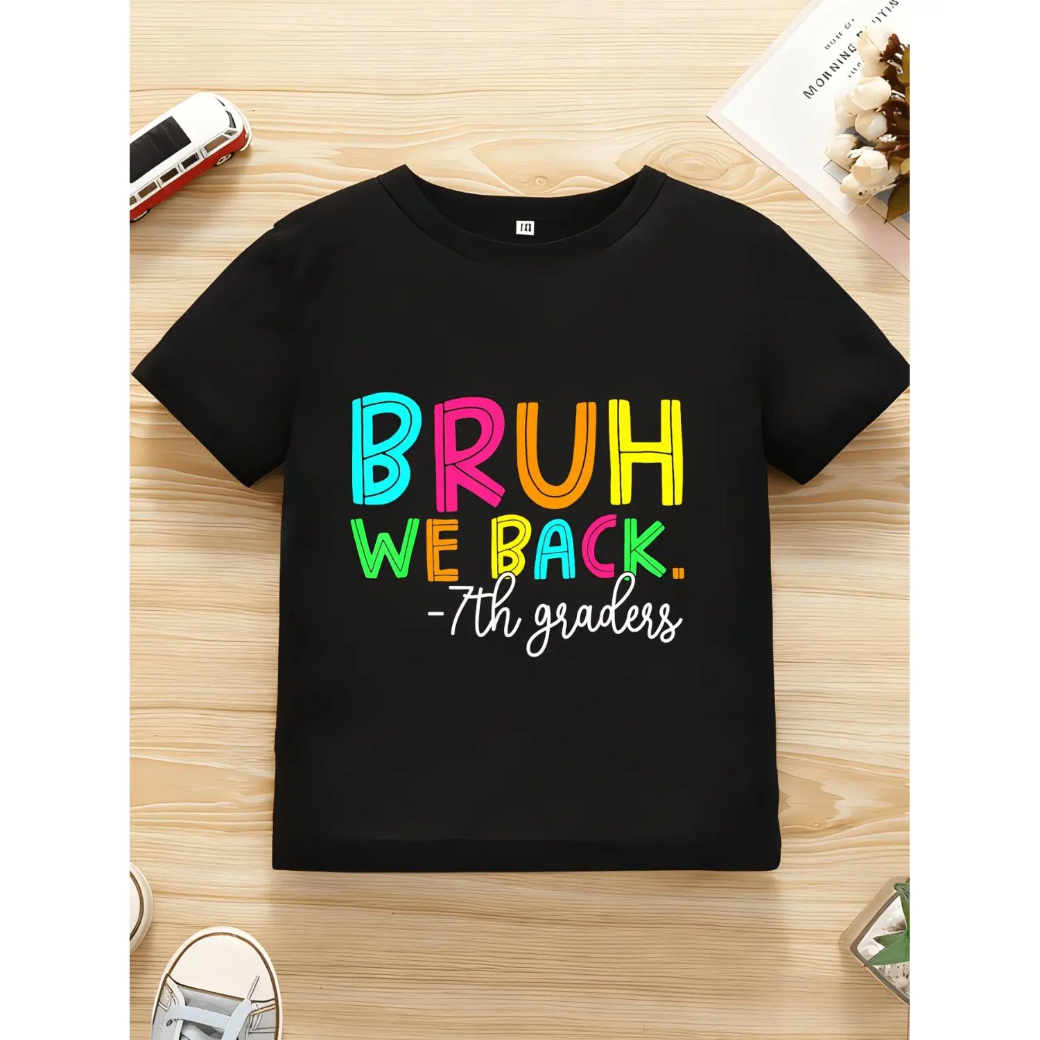 Vibrant 7Th Grade Students Come Back Graphic Tee in Black Featuring Multicolored 'Bruh' Text And Casual Handwritten White Font for School Theme
