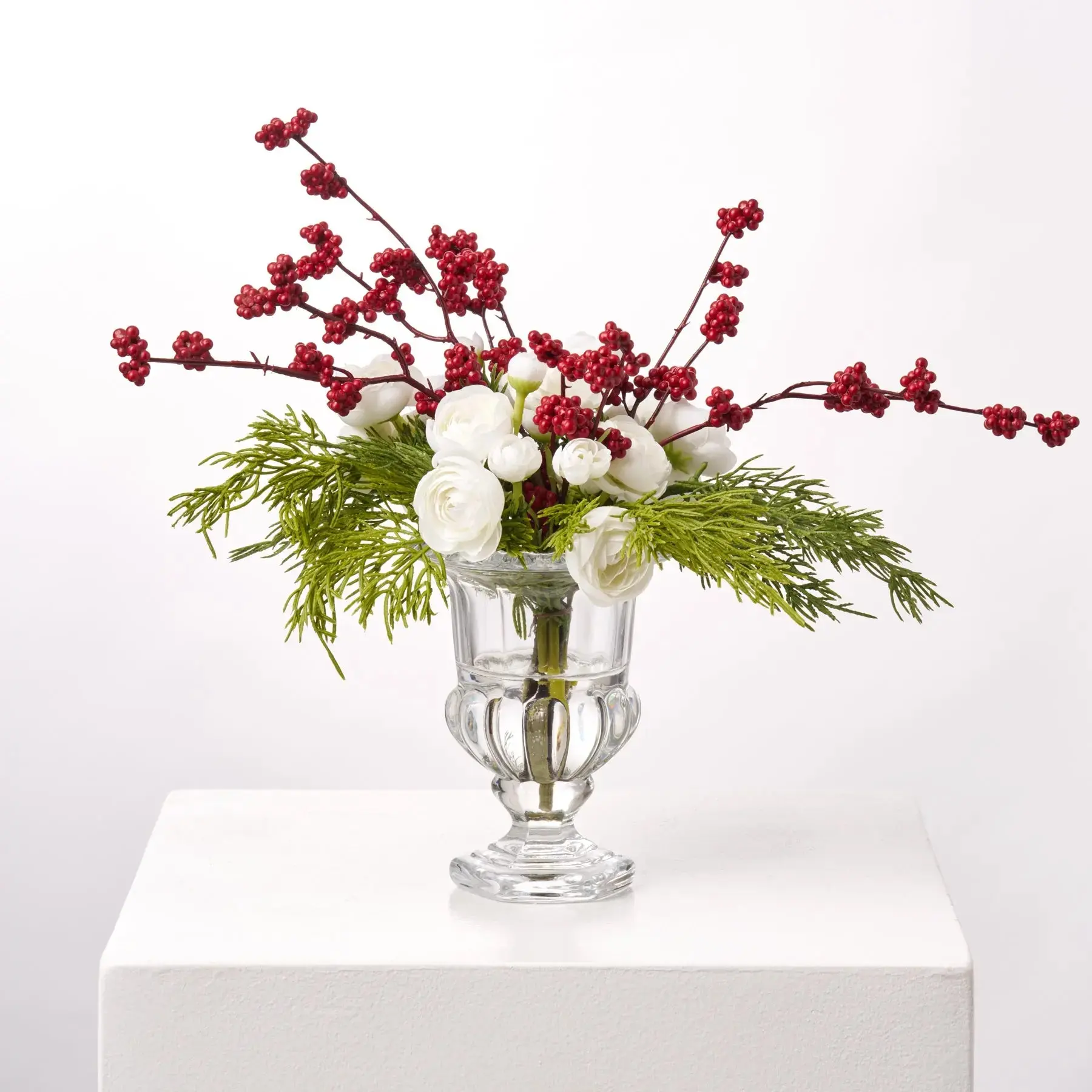 Mini White Ranunculus Blooms & Red Snowberry with Cedar Greens in Small Beveled Glass Urn Holiday Water Illusion Arrangement