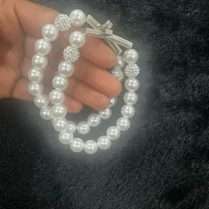 Elegant women’s cross and faux beaded bracelets.