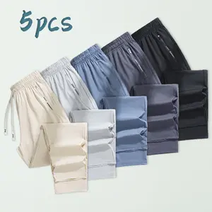 Men’s 5-pack athletic pants featuring moisture-wicking technology, adjustable drawstring waistband, zippered pockets for storage, all-day comfort wear, suitable for sports fitness and travel.