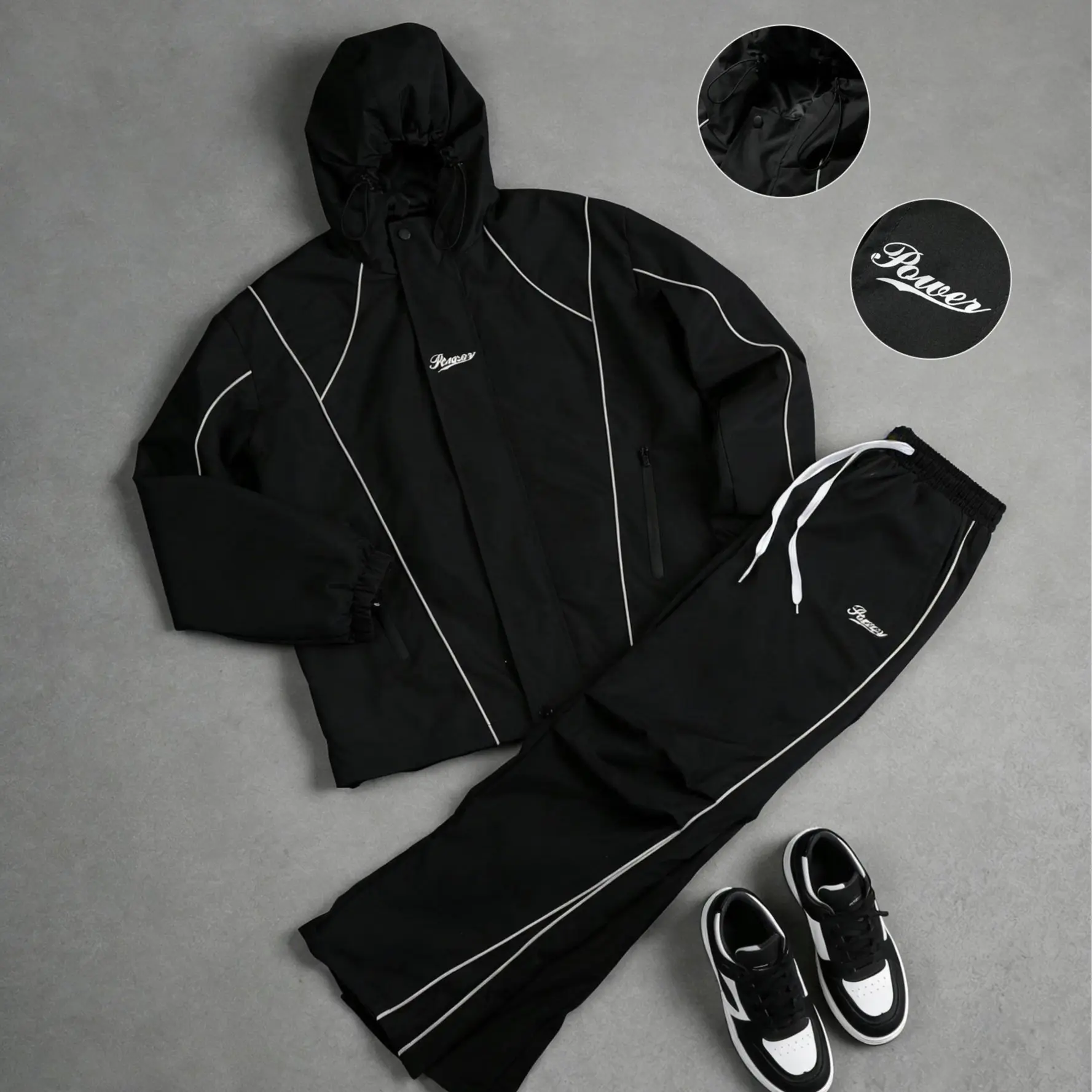 American high-street windproof two-piece set — hooded jacket + long pants, featuring a striped color-block design, letter print, and high-density windproof waterproof fabric, with reinforced stitching. Wear-resistant, wrinkle-resistant, and perfect for ev