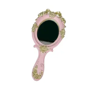 Vintage handheld beauty mirror with a durable resin frame and clear reflection
