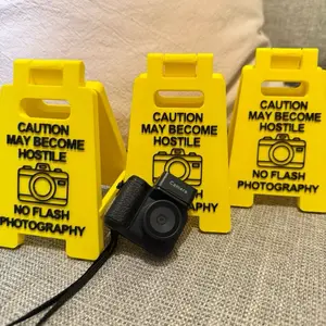 CAUTION: May Become Hostile – No Flash Photography Sign