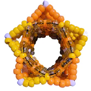 Double X Star Cuff kandi bracelet handmade by me in neon orange and yellow with sparkly orange and yellow Xs accented with white beads