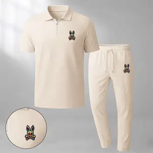 Men's classic two-piece set featuring a short-sleeve polo shirt with a zip collar and the signature Rabbit logo, paired with matching trousers. Crafted from breathable, soft-textured waffle-knit fabric, this set offers a relaxed fit ideal for everyday