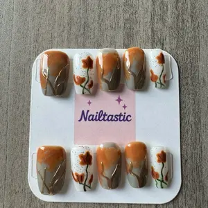 Nailtastic Press on Nails - Elegant Orange & White Flower Design with Gold Accents for Stylish Manicure
