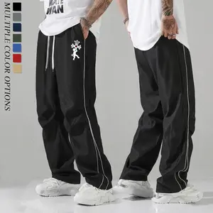 Unisex baggy wide-leg sweatpants; men’s side stripe loose pants with trendy cross print, drawstring elastic waistband, breathable and lightweight; casual street-style pants; Y2K hip-hop skate pants; comfortable home workout pants; suitable for men’s every