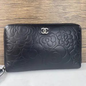 Pre-owned CHANEL Leather Mini Bags black wallet with camellia embossing, zip around design, and silver CC logo. qg2424