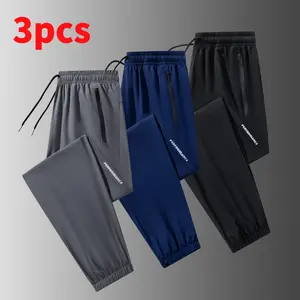 Men’s lightweight jogger pants with stretch fabric, 95% polyester, 5% spandex; elastic waistband with zippered pockets; breathable, quick-drying casual bottoms; men’s sports-casual jogger pants; machine washable.