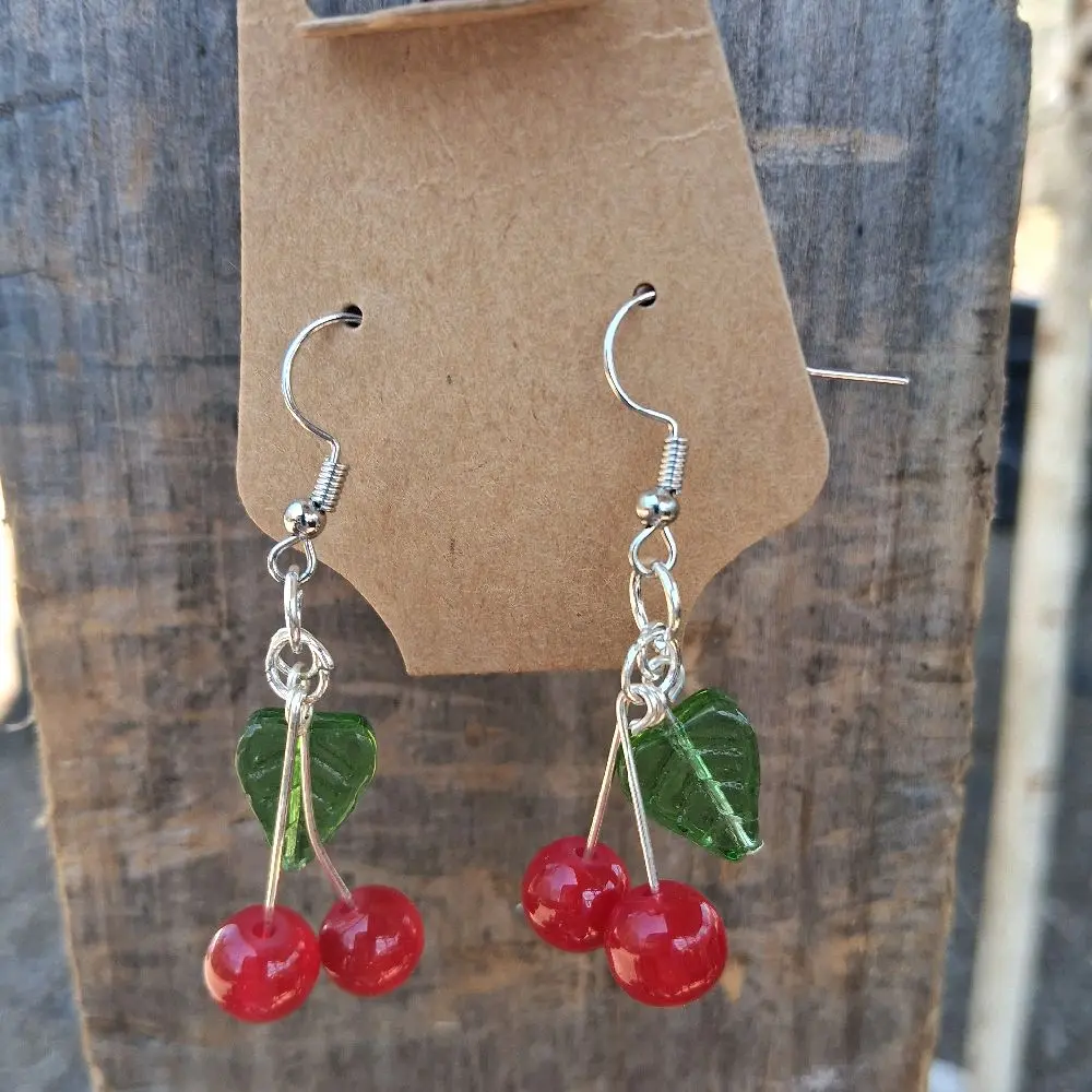 Cherry Charm Earrings - Red Cherry Beads with Green Leaf Accents, Silver Tone Hooks, Perfect for Casual Wear