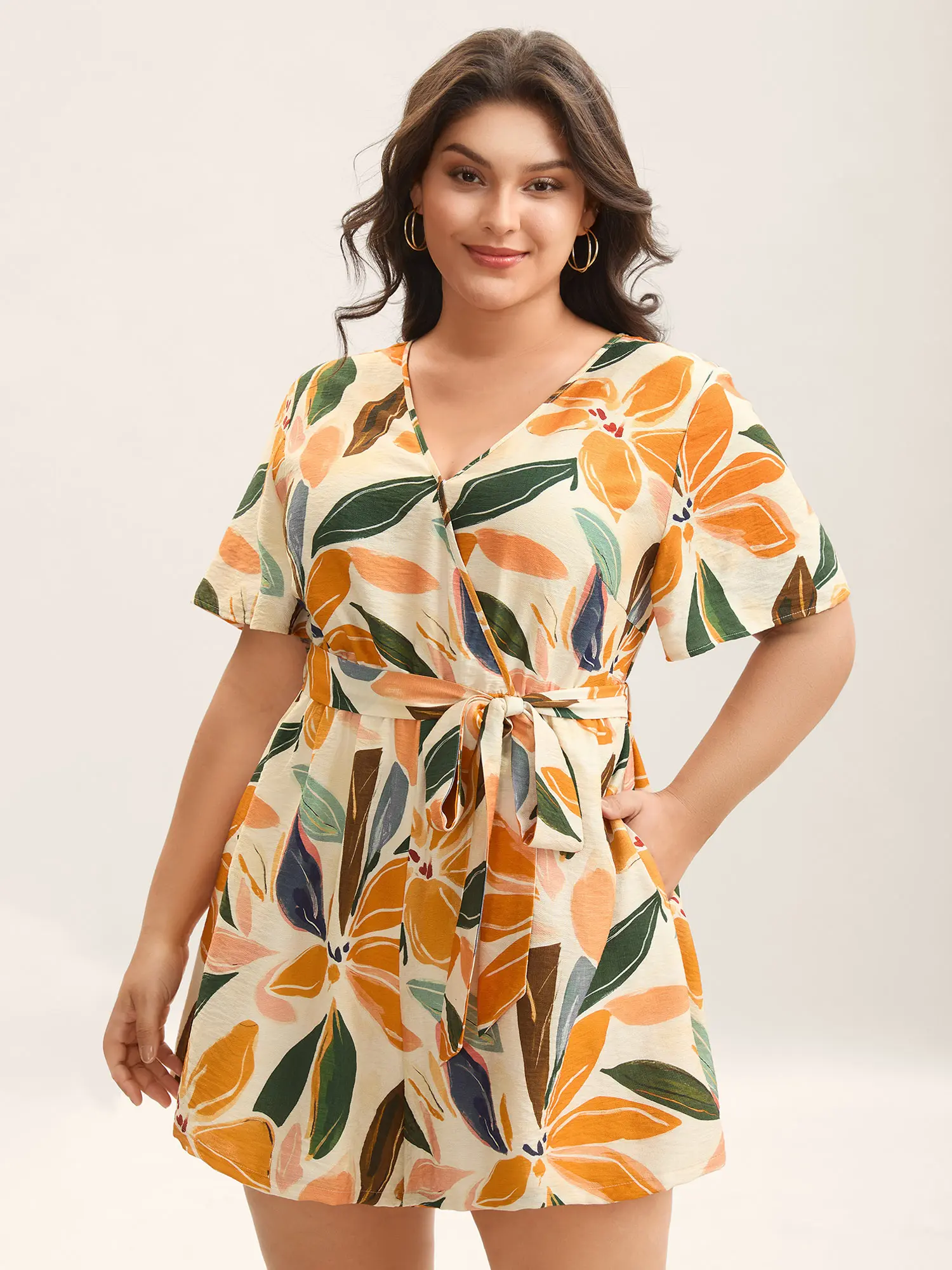 BloomChic Women's Plus Size Boho Floral Romper, Playful Lady's Summer Rayon Garment with an Overlap Collar, Tie-Waist and Pockets