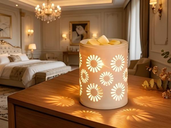 Ceramic electric wax warmer with Edison bulb lighting. It melts scented wax and burns essential oils, featuring sunflower details. Perfect for home aromatherapy and gifting.