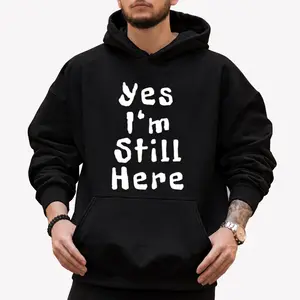 Unisex Long Sleeve Hoodie with Funny 'Yes I Am Still Here' White Print – Relaxed Fit, Black Sleeves, Perfect Gift for Men & Women Summer 2026