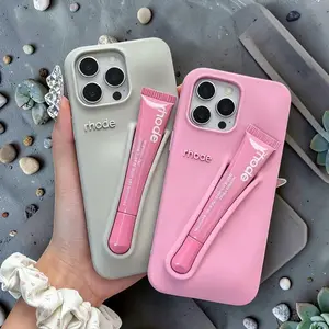 Aesthetic pink phone case with integrated lip gloss holder, gentle silicone protective shell for everyday use, fashionable, minimalist design, soft silicone.