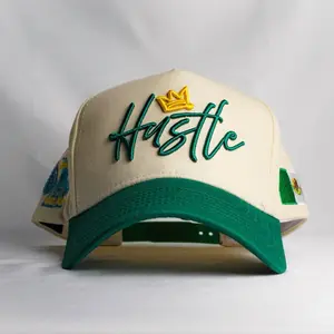 Hustle 5 Panel Hat with Green Embroidery and Gold Crown Design on Cream Background