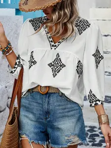 A women's geometric print V-neck, three-quarter sleeve loose-fitting shirt blouse with a beachy vibe that flatters the figure and is versatile.