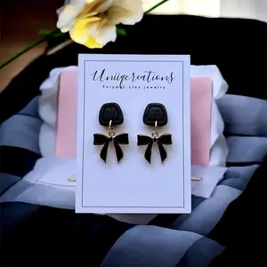 Handmade polymer clay Black bow dangle studs.