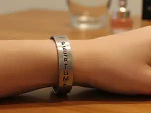 "Perfume never lies" Hand-stamped Aluminum Bracelet
