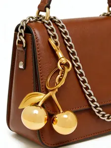 Simple and high-end light luxury texture bag pendant, designed with a simulated fruit cherry shape decoration, widely used as a keychain, suitable for carrying during commuting, gatherings, and shopping