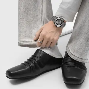 Men’s Black Wrinkle‑Processed Leather Slip‑On Mules. Toe wrinkle detail creates an avant‑garde vibe, soft leather ensures all‑day comfort. Slip‑on style for easy wear, flat sole is ideal for long walks