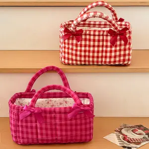 A student dorm essential: small red grid stitched desktop storage basket — compact fabric organizer with butterfly accents, space-saving mini basket for pens, snacks, and cosmetics; ideal for dorm desktop organization.
