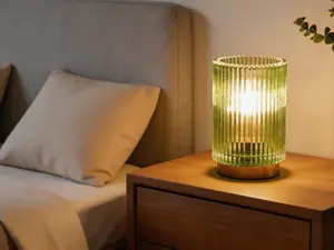 Cordless battery-powered table lamp with timer and warm LED lighting. Featured glass casing in amber tone, suitable for bedroom, bathroom and living room decor.