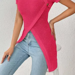 waffle-style rib knit, this top is designed with a flattering sweetheart neckline and distinct asymmetrical button detailing along the bodice. The cross-over front hem creates a dramatic, high-low split effect that pairs perfectly with high-waisted denim