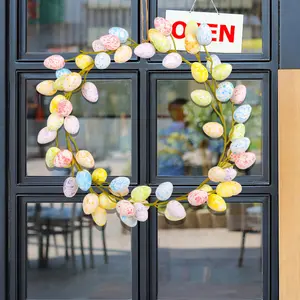Two colorful Easter egg wreaths - creative spring door decoration, no power required, white base, with colorful spotted eggs and leaf branches on it, perfect for Easter home decoration and gift, holiday window display. Spring decoration, Easter decoration
