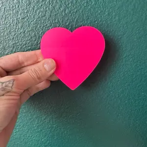 Pink transparent heart shaped sticky notes for book annotation