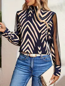 A ladies' geometric print patchwork netting long-sleeved high-neck fitted blouse with elegant style and versatile appeal