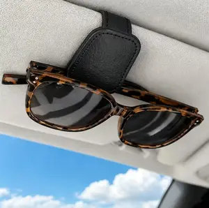 A glasses holder designed specifically for cars, featuring an integrated clip with multifunctional card storage and storage capabilities. Made of durable leather, it is portable and an ideccessory for the interior of various car models.