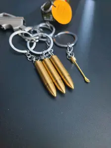 A golden metal keychain in the shape of a bullet, equipped with a sturdy metal pendant for the ear, suitable for car keys, backpacks, wallets - it is a fashionable accessory for both men and women.