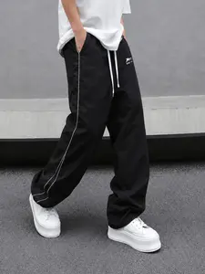 Men’s black joggers with side piping, wide straight legs, drawstring, loose fit—casual long pants in American street style, suitable for all seasons.