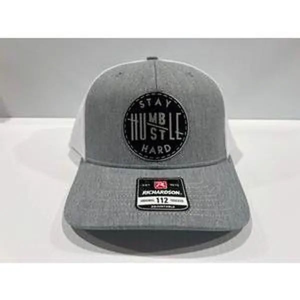 Stay Humble Hustle Hard Hat Leatherette patch hat is a Richardson 112 Trucker Hat with adjustable snapback.