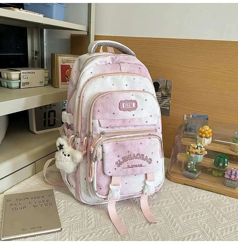 Large-capacity multi-layer backpack, a cute pink bag featuring star design and white bow details, suitable for students.