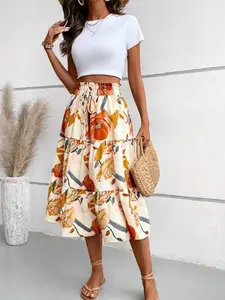 A high-waisted, drawstring, mid-length skirt with multiple layers of ruffles, featuring large orange-yellow floral prints on an off-white background, exuding a fresh, pastoral vacation vibe; suitable for relaxed occasions like park picnics, seaside vacati