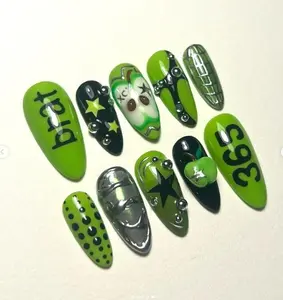 Edgy neon green nail art with stars, apples, chrome details, and bold text like “brat” and “365,” inspired by Y2K and Charli XCX vibes.