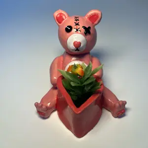 Teddy Bear Plant Pot - Pink Bear Design with Heart Eyes Holding a Succulent Plant Container