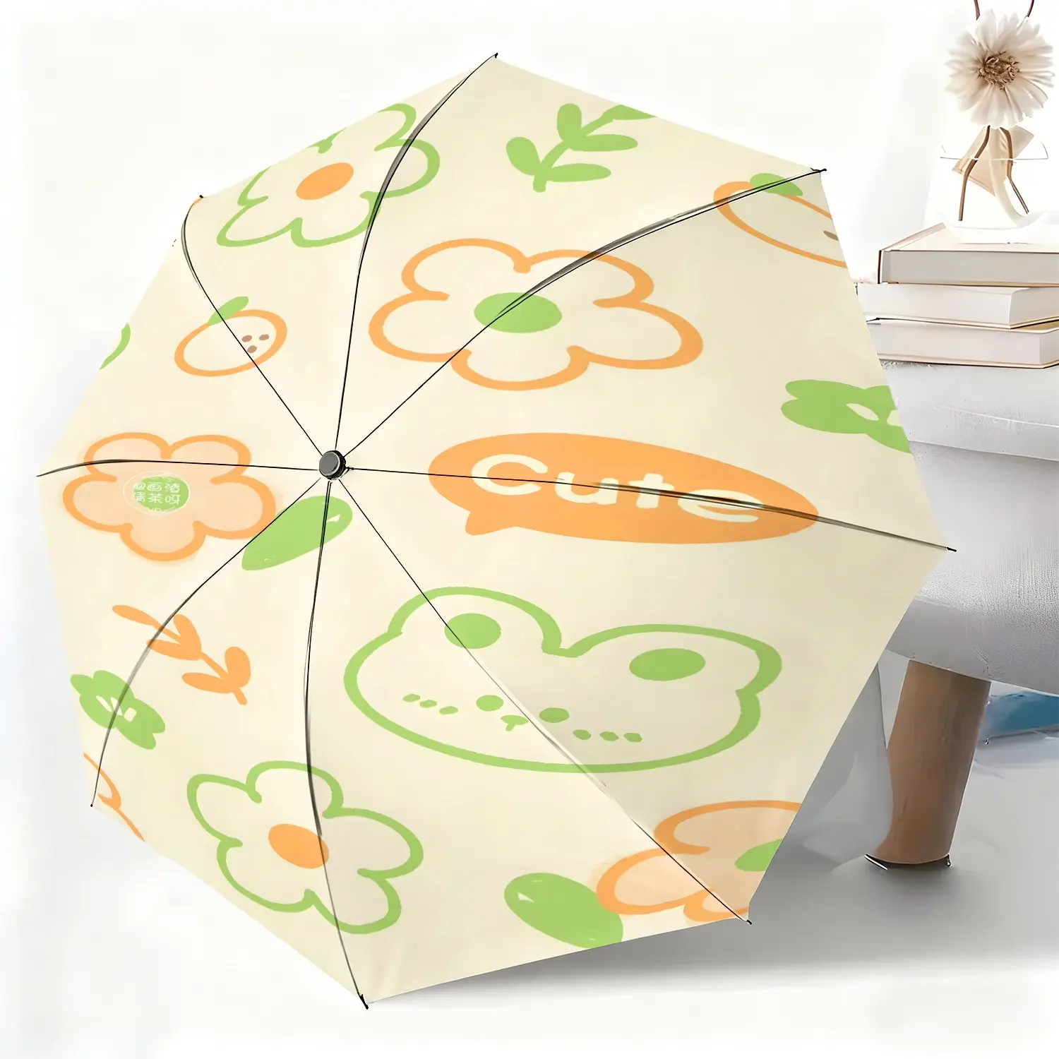 This waterproof folding umbrella features a cartoon frog and flower pattern, is made of fabric, and is suitable for both men and women. It's portable and perfect for travel and everyday use.