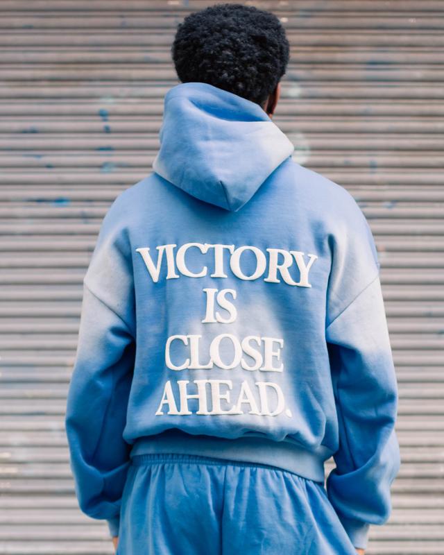 "VICTORY IS CLOSE AHEAD" SUNFADE HOODIE (CLOUD BLUE/ PUFF WHITE)