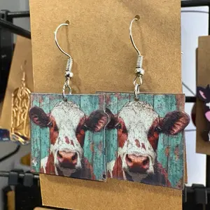 Cow Print Earrings Rustic Farmhouse Style with Distressed Teal Background and Silver Hooks for Casual Wear