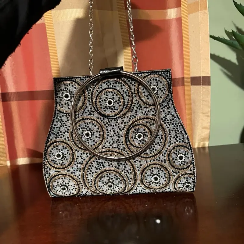 Silver and Gold Beaded Clutch with Elegant Circular Embellishments and Secure Chain Strap